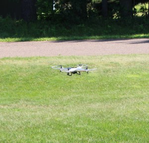 Drone_flying_with_green_grass_and_road_backdrop6-25-16
