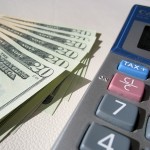 Sales Tax Accounting. Money and a calculator, online small business accounting for the self-employed