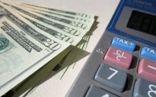 Money and a calculator, online small business accounting for the self-employed