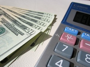 Money and a calculator, online small business accounting for the self-employed