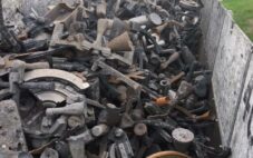 semi truck and trailer with scrap metal filling the holding bin of the trailer