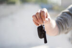 save on car insurance, picture of a person offering they keys to a car insured with 1 Reason Insurance